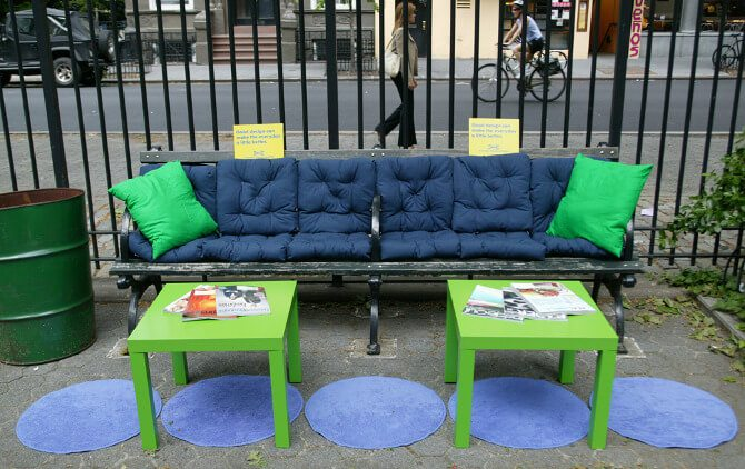 Guerrilla Marketing Example - IKEA decorated city benches to make them more like a home with blue and green pillow 