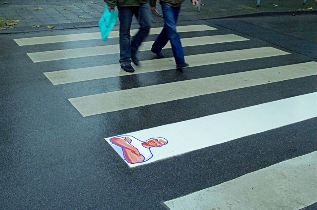 Guerrilla Marketing Example Mr Clean - Image of a people walking at a cross walk and one line is more white than the others 