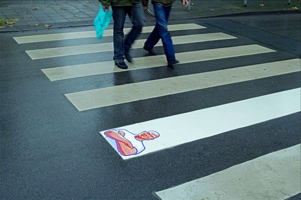 Guerrilla Marketing Example Mr Clean - Image of a people walking at a cross walk and one line is more white than the others
